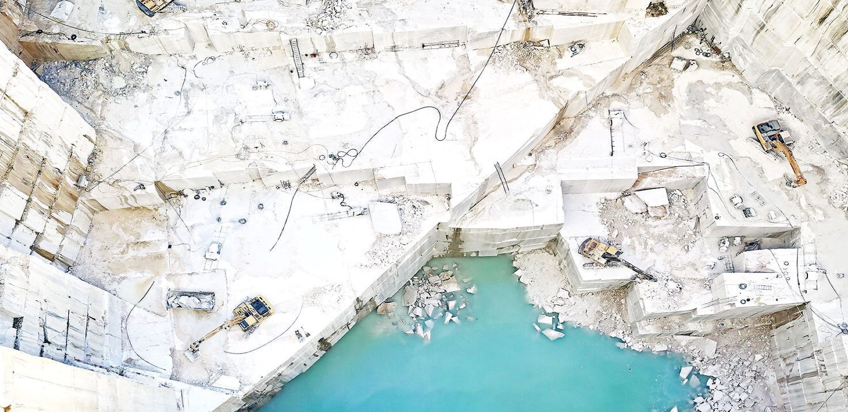 Marble Quarry Perspectives: Capturing Nature'S Artistry 2 Nestled in Portugal's Estremoz region, the Estremoz White Marble quarry is a testament to the harmony of nature and human craftsmanship. This quarry features exquisite white marble with intricate veining that exudes radiance when touched by sunlight. It reflects the collaboration between artisans and modern technology to shape the marble into various forms while preserving its geological and cultural significance. The quarry offers a glimpse into Earth's history and artistic potential, standing as a timeless testament to both human creativity and the beauty inherent in nature's design.
