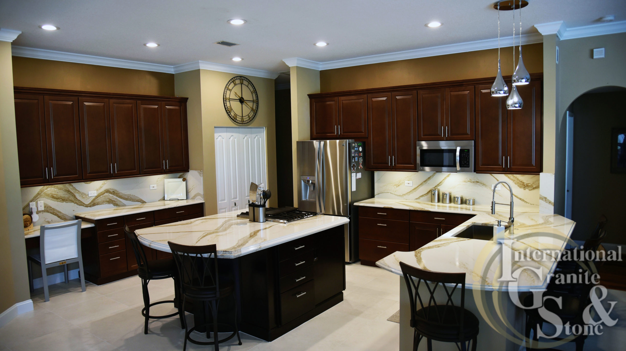 Brittanicca Gold Cambria Quartz Countertops in Kitchen with Backsplash and Dark Wood Cabinets in Fitzgerald Home Remodel