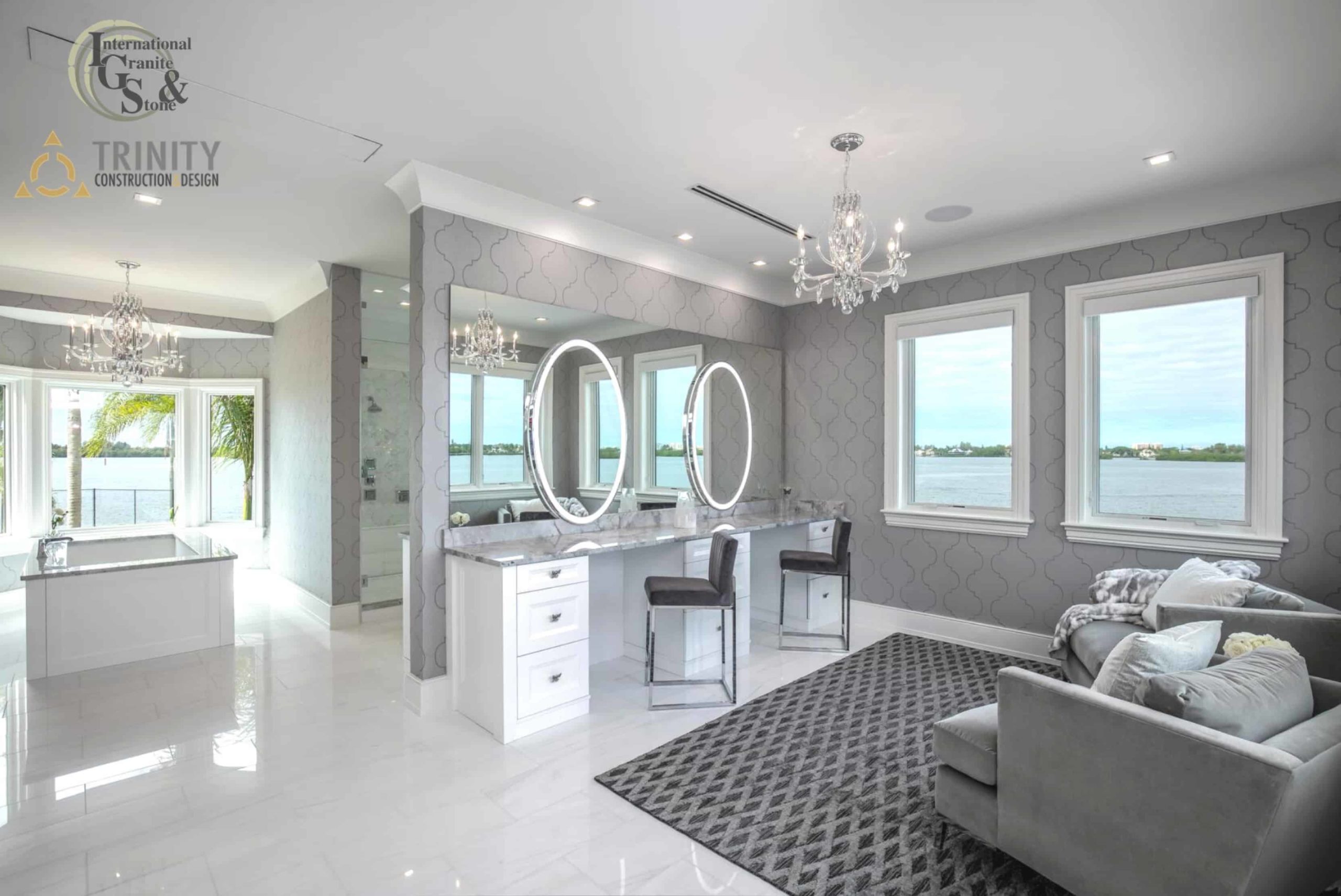 Magazine Worthy Cambria Brittanicca Sarasota Luxury Remodel 5 Super White Quartzite Calcatta Quartzite Marble Countertops Bathroom Countertops Bathtub Surround Countertop International Granite and Stone Trinity Construction and Design Ryan Gamma Photographer Double Bathroom Vanity White Cabinets White Tile Gray Tile White and Gray Bathroom Make Up Table Make-Up Vanity Tub Surround