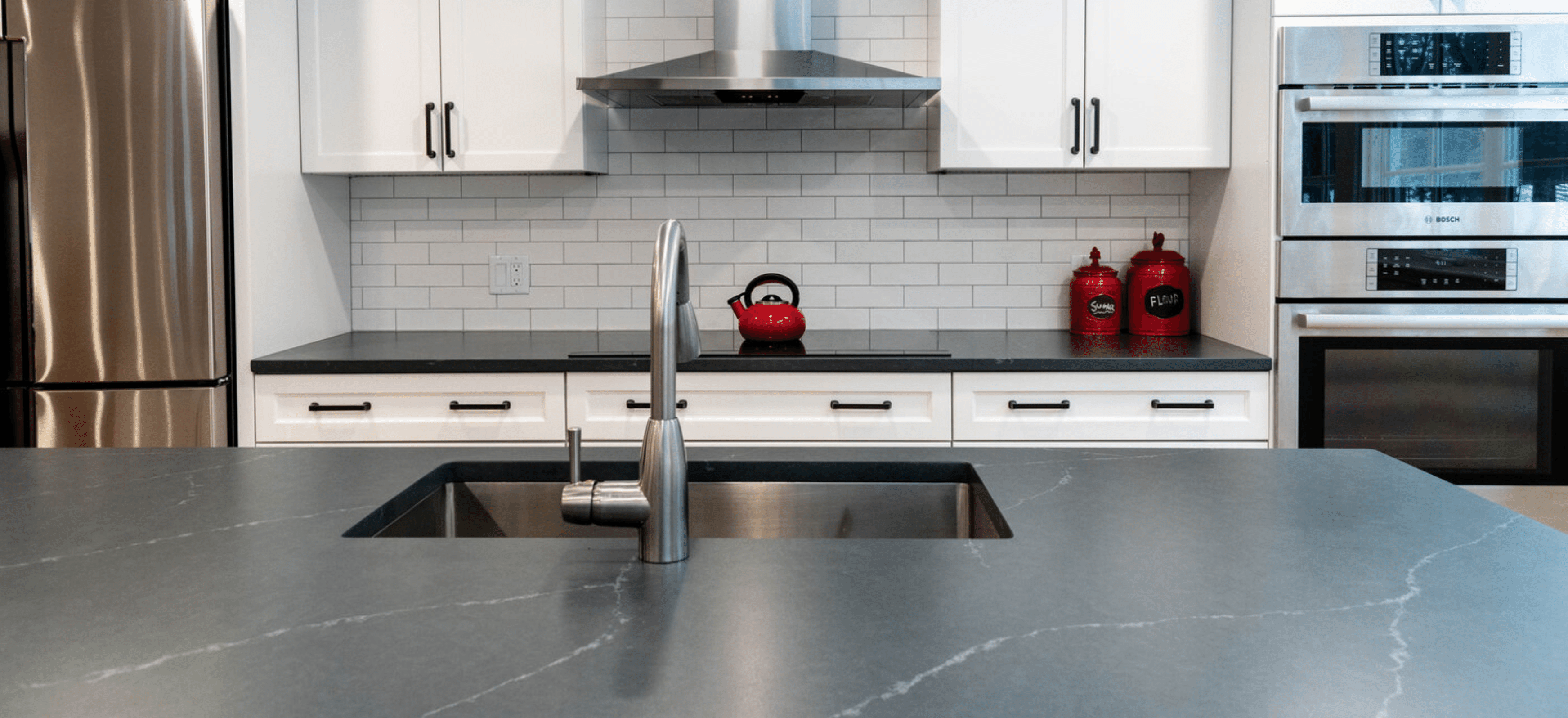 One Of A Kind: A Complete Guide To Natural Stone Countertops 3 Charcoal Soapstone Kitchen Countertops and Island with White Subway Tile Backsplash Natural Stone Countertops