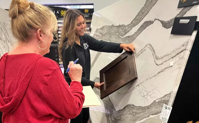 Dont Buy Granite! : Health Concerns And Risks Associated With Old Countertops 4 Customer in showroom being helped square optimized scaled e1709848609412 | Countertops