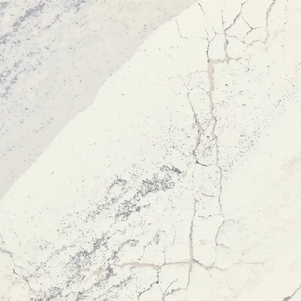 Close-up view of Cambria Windsor Steel Satin Ridge Quartz, showcasing its steel-toned wave patterns, warm honey-colored sand backdrop, and contrasting cool charcoal elements.
